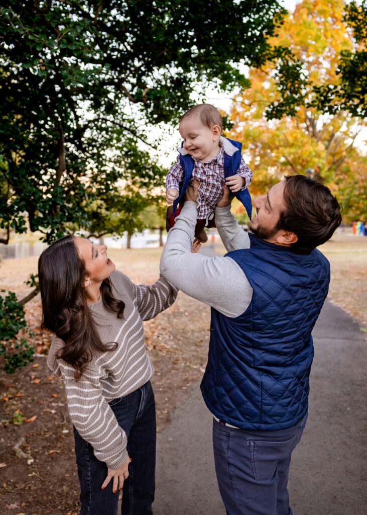 Family in Taylor Park surrounded by fall leaves